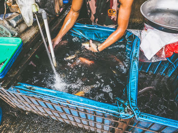 High angle view of man selling fish at market