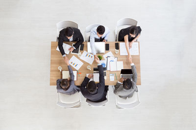 High angle view of business people discussing in meeting at office
