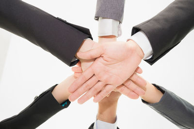 Midsection of couple holding hands