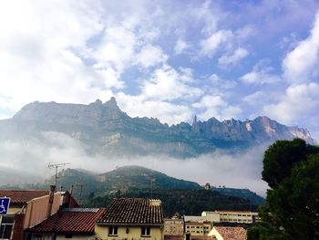 Panoramic view of houses and trees against sky