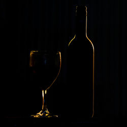 Close-up of wine bottles against black background