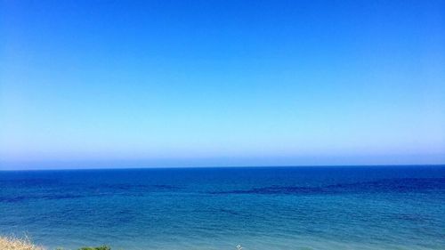 Scenic view of sea against clear blue sky