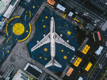 High angle view of airplane flying over city