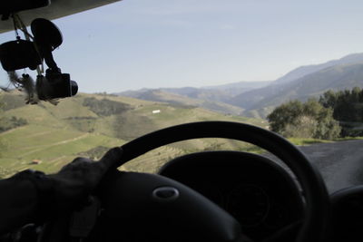 Close-up of car on mountain against sky