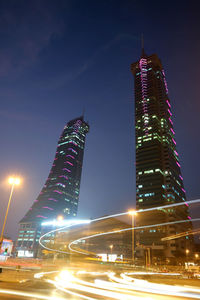 Illuminated buildings against sky at night