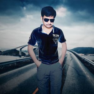 Young man wearing sunglasses standing on railroad track against sky