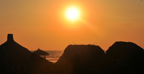 Scenic view of silhouette mountain against clear sky during sunset