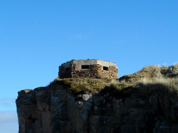 Low angle view of built structure against clear blue sky