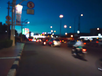 Close-up of illuminated street lights at night