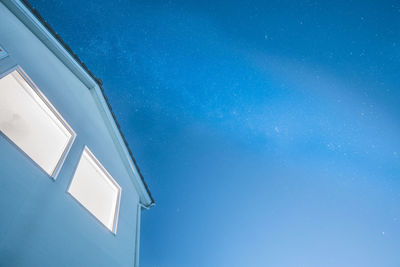 Low angle view of building against blue sky at night