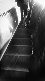 Woman standing on escalator