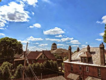 Houses against cloudy sky