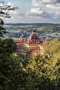 High angle view of trees and buildings against sky