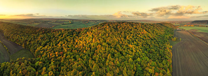 Scenic view of land against sky during sunset