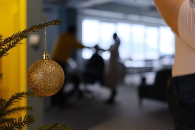 Cropped hand of woman holding christmas decoration