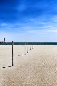 Scenic view of beach against blue sky