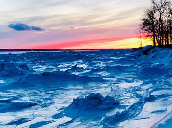 Scenic view of frozen sea against sky during winter