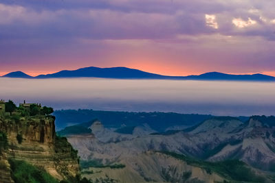 Scenic view of mountains against cloudy sky