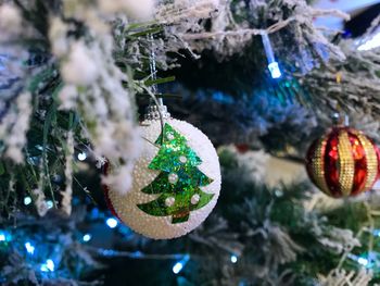 Close-up of christmas decorations hanging on tree