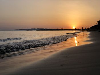 Scenic view of beach against sky during sunset