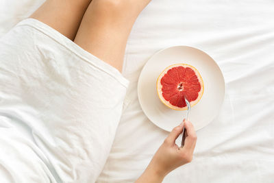 High angle view of woman holding ice cream