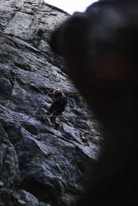 Man surfing on rock against sky