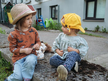 Portrait of siblings sitting on field