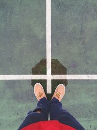 Low section of person standing on tiled floor
