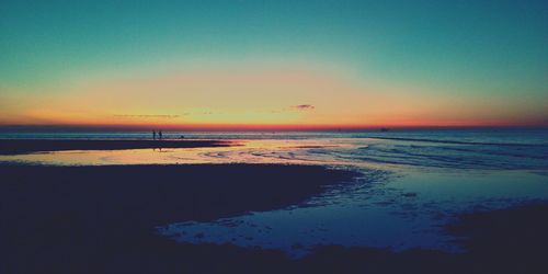 Scenic view of sea against clear sky at sunset