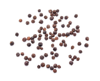 High angle view of coffee beans against white background