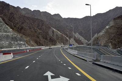 Road amidst mountains against sky