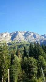 Scenic view of mountains against blue sky