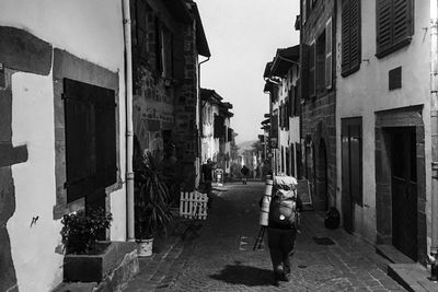 Narrow street amidst buildings in city