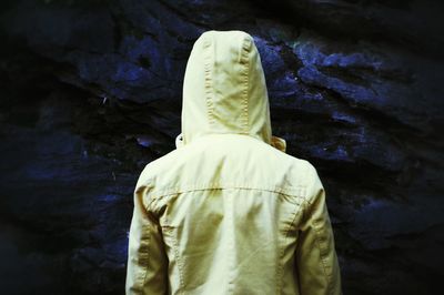Rear view of person wearing hood