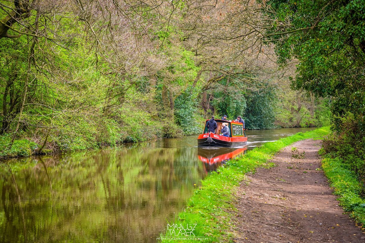 transportation, water, mode of transport, tree, nautical vessel, boat, river, growth, reflection, lifestyles, nature, canal, green color, plant, men, travel, leisure activity, tranquility