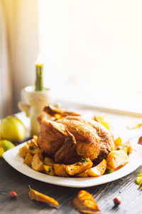 Autumn composition with leaves, ripe pumpkin and thanksgiving turkey on a dark wooden table.