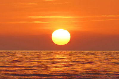 Scenic view of sea against orange sky