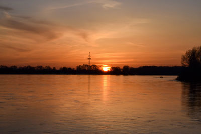 Scenic view of lake against orange sky