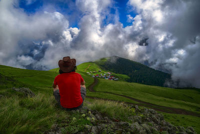 Rear view of man standing on mountain