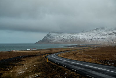 Road by land against sky during winter
