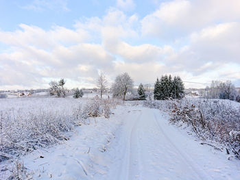 Snow covered road against sky