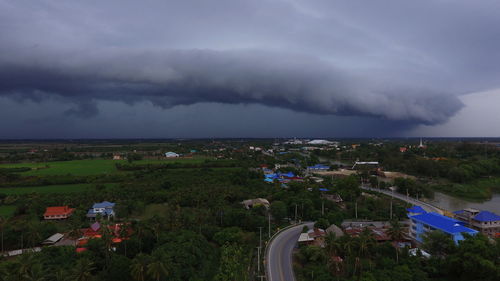 High angle shot of cityscape against cloudy sky