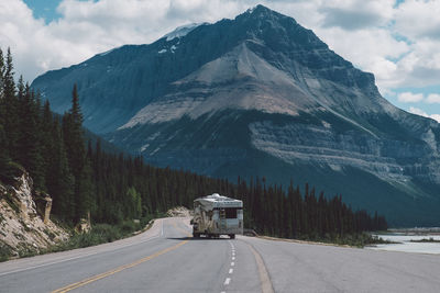Vehicle on road against mountain