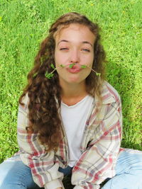 Portrait of smiling young woman in grass