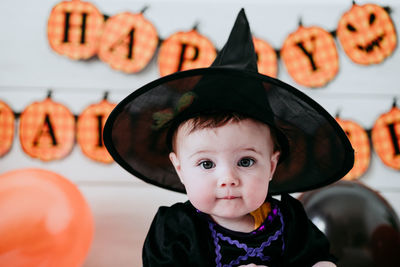 Portrait of cute girl wearing costume at home