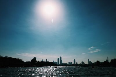 Silhouette buildings in city against sky