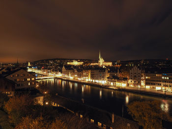 High angle view of city lit up at night