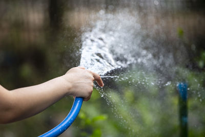 Midsection of man splashing water