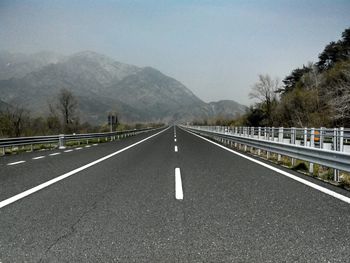 Empty road with mountains in background