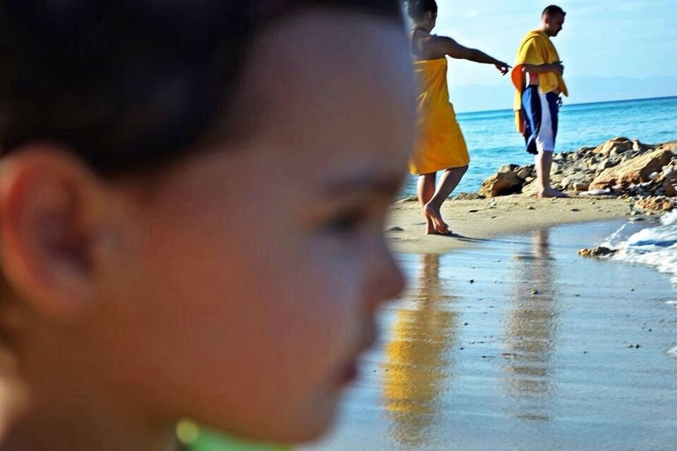 water, beach, sea, lifestyles, leisure activity, shore, sand, horizon over water, men, vacations, walking, full length, wave, boys, standing, rear view, childhood, nature